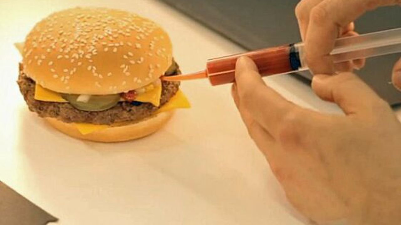 the_condiments_are_applied_delicately_with_a_syringe_47399100