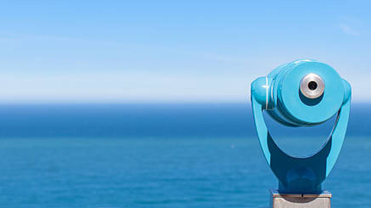 panorama of binoculars and ocean in the background