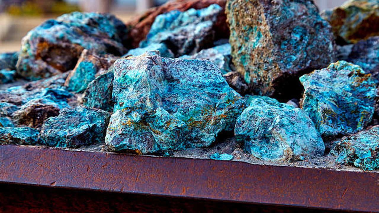 Chunks of copper ore mineral rocks in an iron barrel