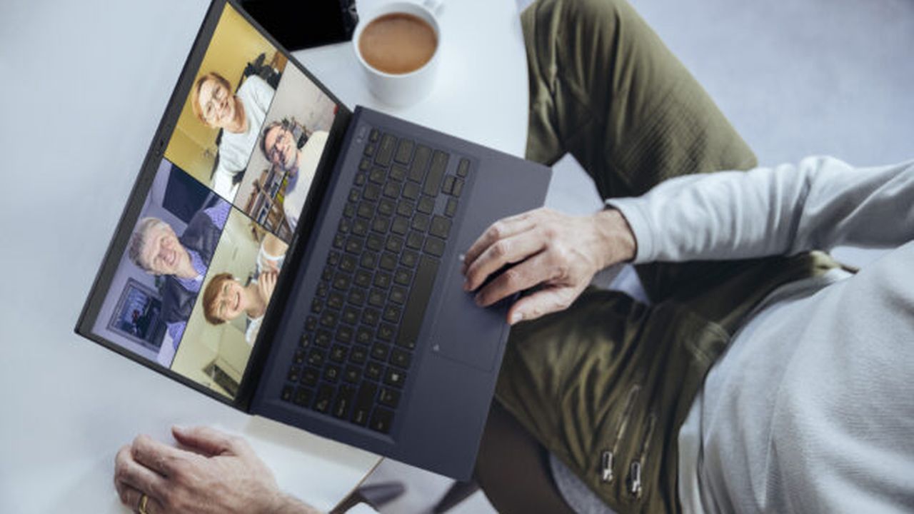 Man having a conference call at home, using laptop