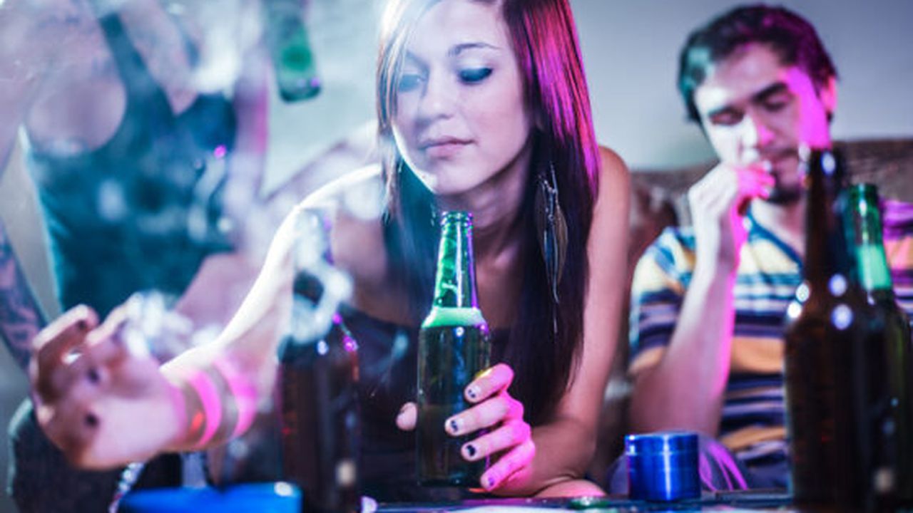 girl putting joint in ashtray at crazy party