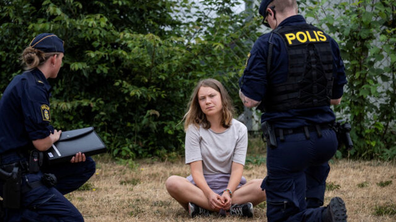 FILE PHOTO: Police talk to Greta Thunberg as they move climate activists who are blocking the entrance to Oljehamnen in Malmo