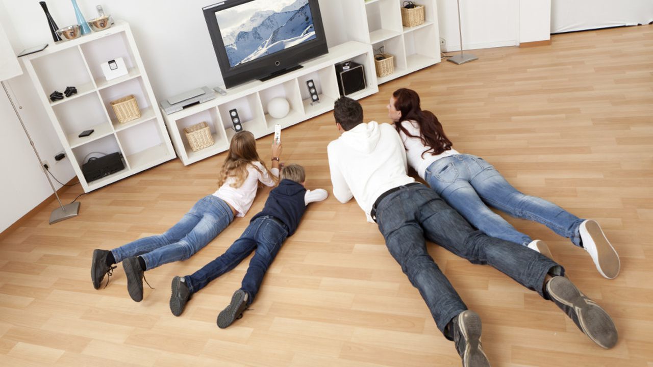 Young family watching TV at home