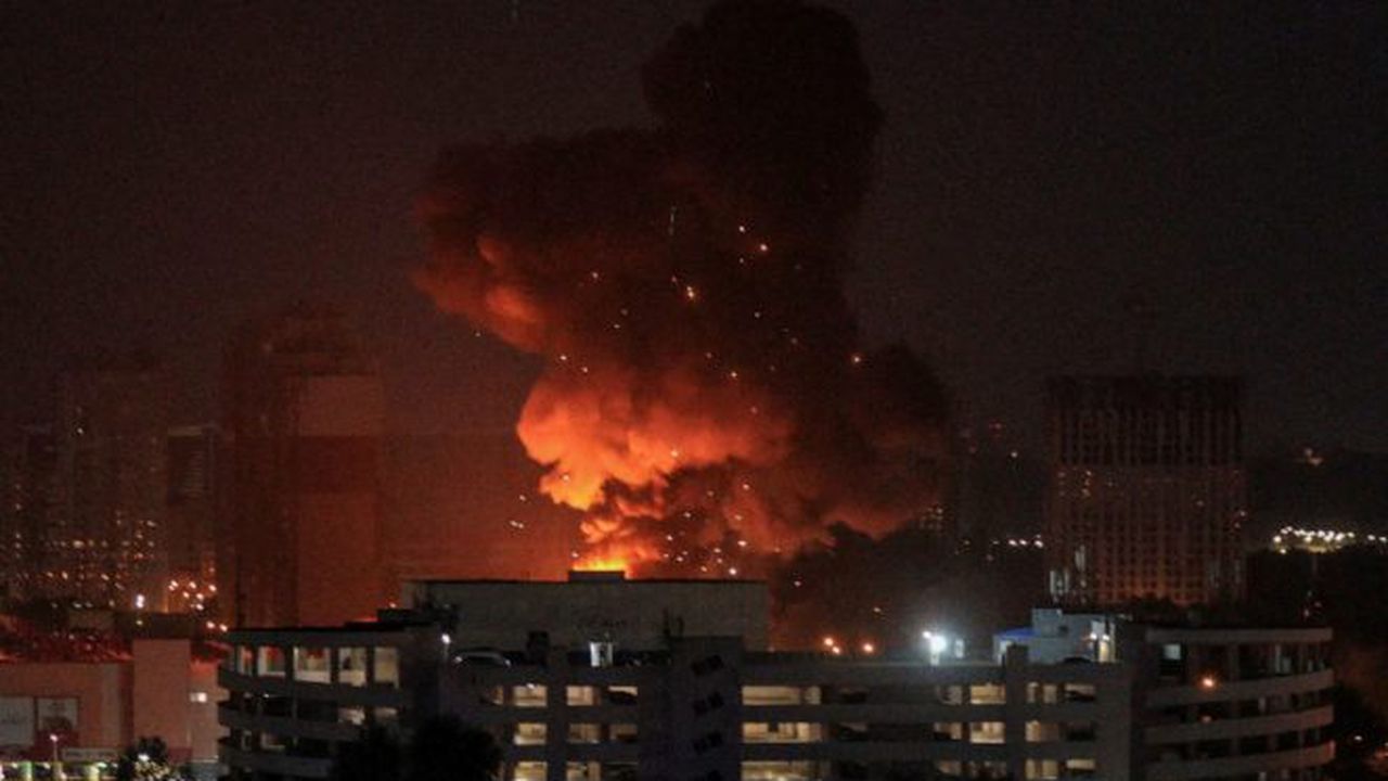 An explosion is seen in the sky over the city during a Russian missile strike in Kyiv