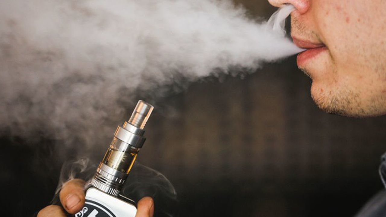 A man smokes an electronic cigarette vaporizer, also known as an e-cigarette, in Toronto