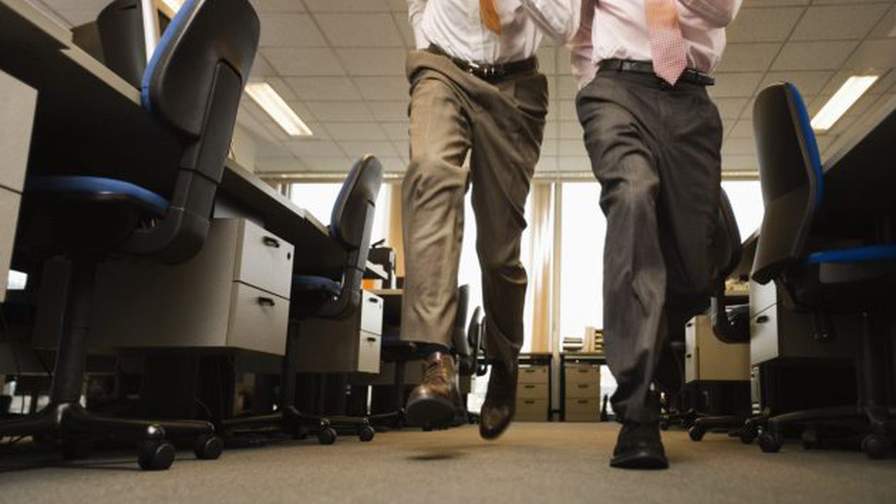 Two Businessmen Running in Office